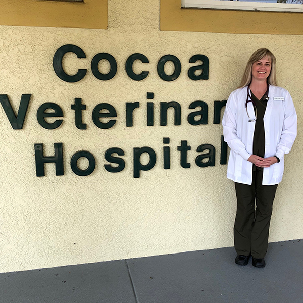 Dr. Crider standing by Cocoa Veterinary Hospital sign